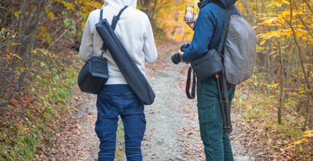 Photographer in backpack at forest.