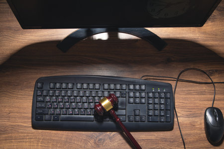 Computer with a wooden judge gavel.の写真素材