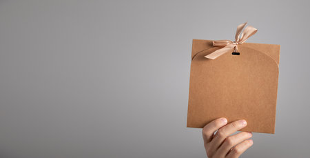 Caucasian man showing a gift box.