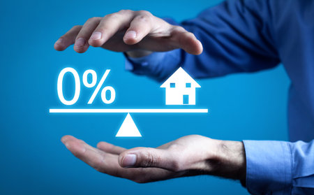 Zero percent symbol and house model on scales. Real estateの写真素材