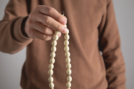 Caucasian man holding beads.の写真素材