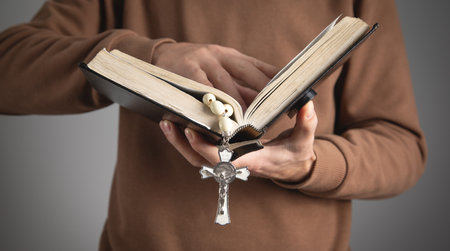 Man with a Holy Bible and rosary beads.の写真素材