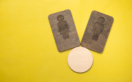 Male and female wooden symbol with an empty space.の写真素材