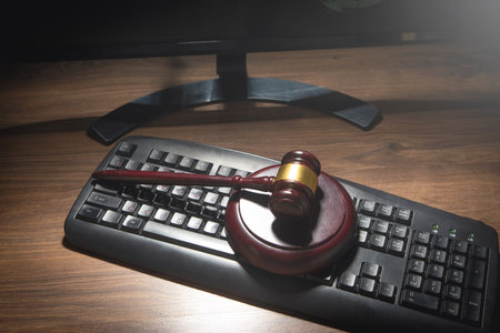 Computer with a wooden judge gavel.の写真素材
