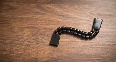 Rosary beads on the wooden background.の写真素材