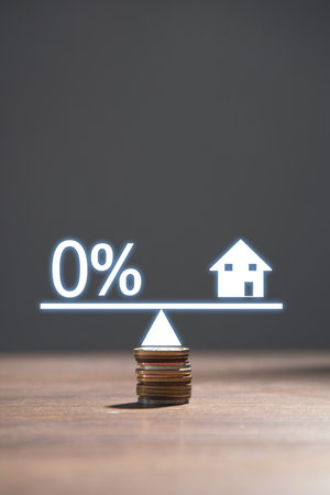 Zero percent symbol and house model on scales. Real estateの写真素材