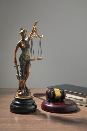 Lady Justice statue, judge gavel, book on the table.の写真素材