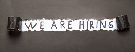We Are Hiring description under the torn paper.の写真素材
