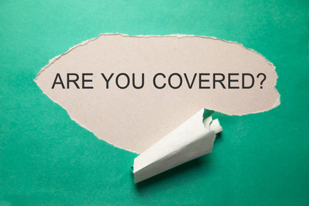 Are You Covered? inscription on torn paper.の写真素材