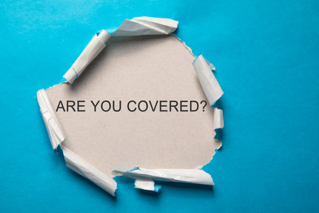 Are You Covered? inscription on torn paper.の写真素材