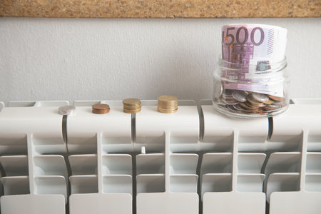Coins on heating radiator at home.の写真素材