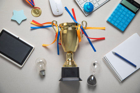 Golden winner trophy cup with a business objects.の写真素材