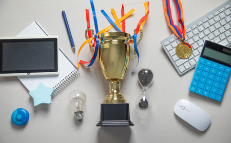 Golden winner trophy cup with a business objects.の写真素材