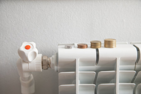 Coins on heating radiator at home.の写真素材