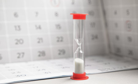 Hourglass and calendar. Time running out