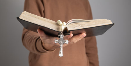 Man with a Holy Bible and rosary beads.の写真素材
