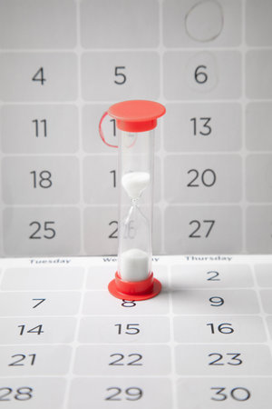 Hourglass and calendar. Time running outの写真素材