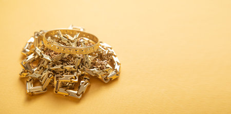 Golden jewelry on the yellow background. Fashionの写真素材