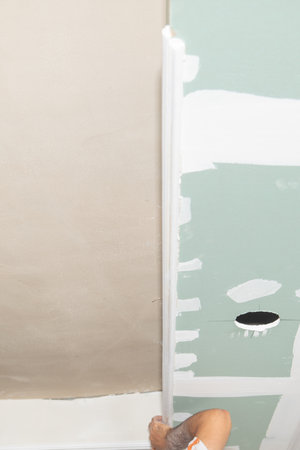Caucasian worker renovating ceiling at home.の写真素材