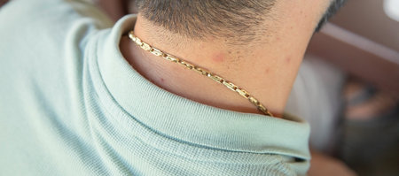 Caucasian man with a golden necklace.の写真素材
