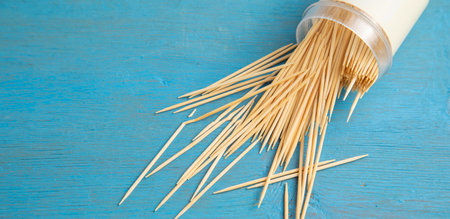 Wooden toothpicks on the blue background.の写真素材