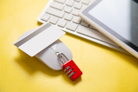 Padlock, credit card, computer keyboard on the yellow background.の写真素材