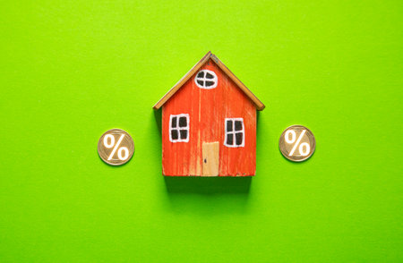 House model and percent symbol on the green background.の写真素材