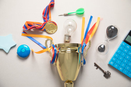 Golden winner trophy cup with a business objects.の写真素材