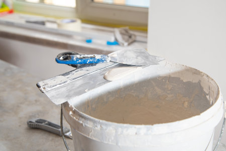 Bucket with a spatula for leveling.の写真素材