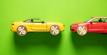 Toy car and percent symbol on the green background.の写真素材