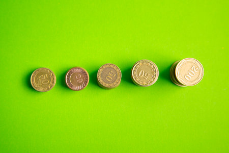Stack of coins on the green background.の写真素材