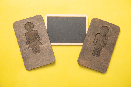 Male and female wooden symbol with an empty space.の写真素材