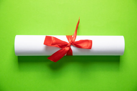 Diploma on the green background. Educationの写真素材