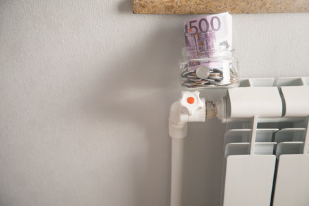 Coins on heating radiator at home.の写真素材