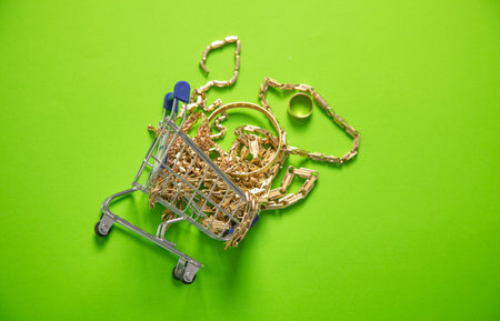 Shopping cart with golden jewellery.の写真素材