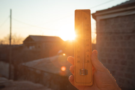 Thermometer on sky background. Sunset. Weather