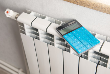 Calculator with a heating radiator at home.の写真素材