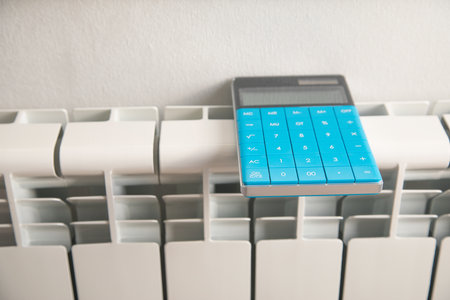 Calculator with a heating radiator at home.の写真素材