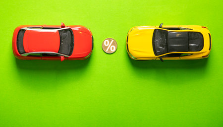 Toy car and percent symbol on the green background.の写真素材