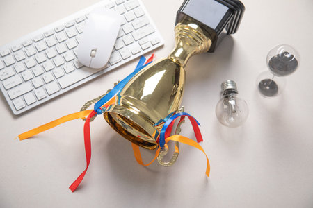Golden winner trophy cup with a business objects.の写真素材