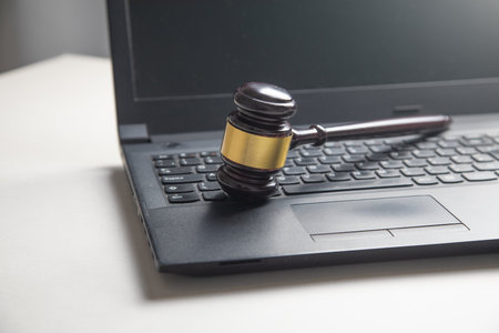 Black laptop computer with a judge gavel.の写真素材