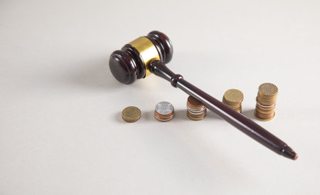 Judge gavel and coins on the table.の写真素材