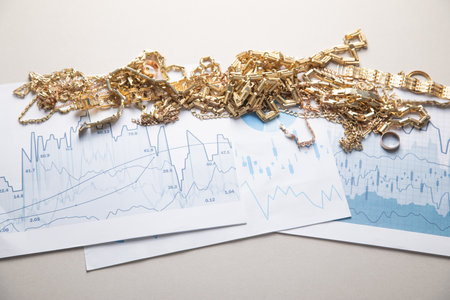 Golden jewelry on financial graphs.の写真素材