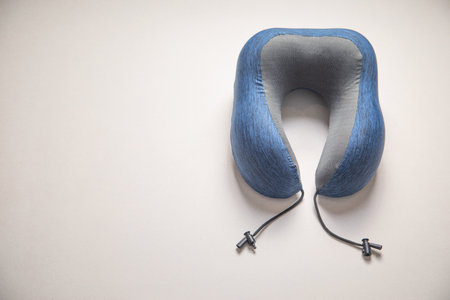Neck pillow on gray background. Comfort and relaxationの写真素材