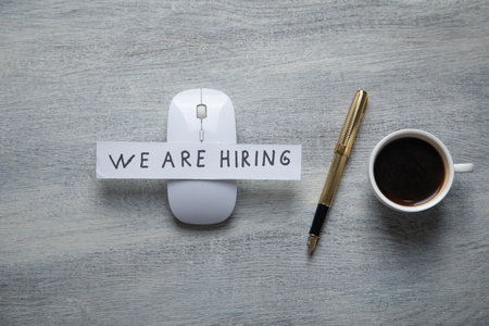 We Are Hiring message on paper with a pen.の写真素材