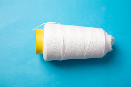 Close up of spool of white thread.