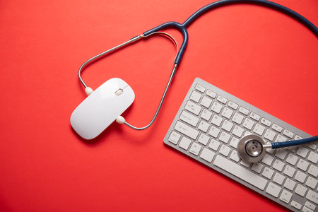 Stethoscope with a computer keyboard and mouse.の写真素材