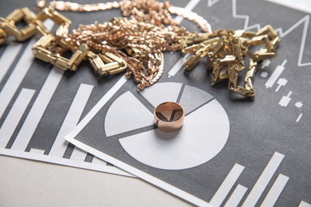 Golden jewelry on financial graphs.