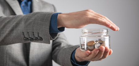 Man showing jar of coins. Businessの写真素材