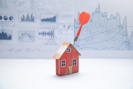 Dart arrow, house model with a financial graphs.の写真素材